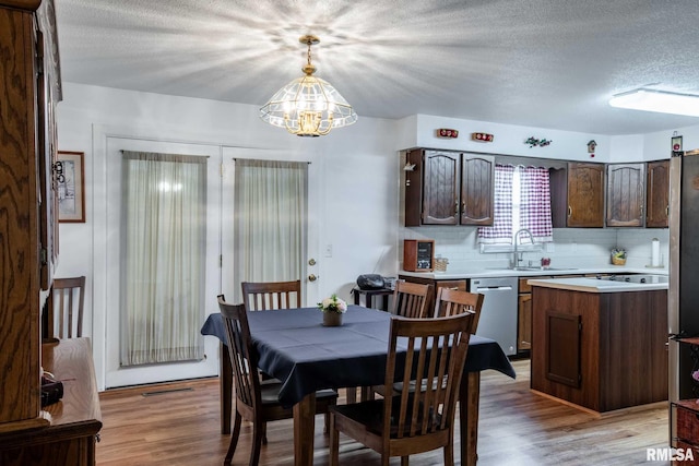 1903 Melvin Rd, West Frankfort, IL 62896 - dining area featuring a chandelier, light wood-style flooring, and a textured ceiling