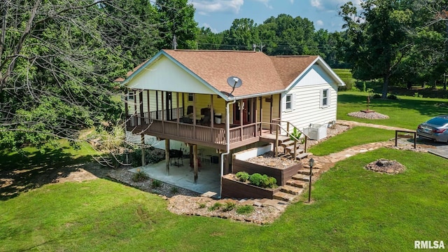 5680 State Route 146 E Highway, Vienna, IL 62995 - back of property featuring a patio area, a lawn, a shingled roof, and a wooden deck
