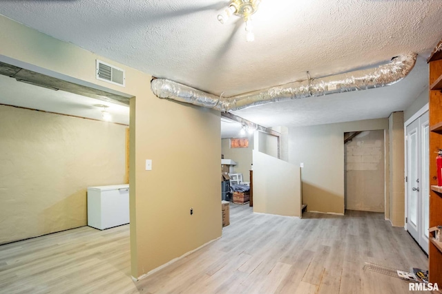 5680 State Route 146 E Highway, Vienna, IL 62995 - finished below grade area with wood finished floors, a textured ceiling, and fridge