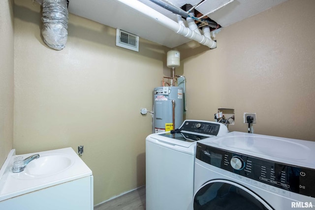 5680 State Route 146 E Highway, Vienna, IL 62995 - laundry room with separate washer and dryer, gas water heater, and light wood finished floors