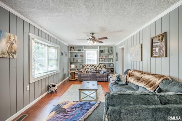 5680 State Route 146 E Highway, Vienna, IL 62995 - living room featuring ornamental molding, healthy amount of natural light, wood finished floors, a textured ceiling, and ceiling fan