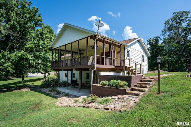 5680 State Route 146 E Highway, Vienna, IL 62995 - back of property featuring a ceiling fan, a patio, a lawn, and a deck
