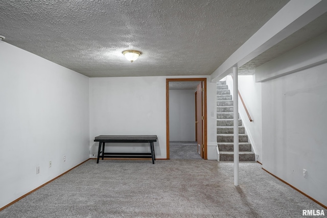1817 W 3rd St, Milan, IL 61264 - finished basement featuring carpet floors, a textured ceiling, and stairway