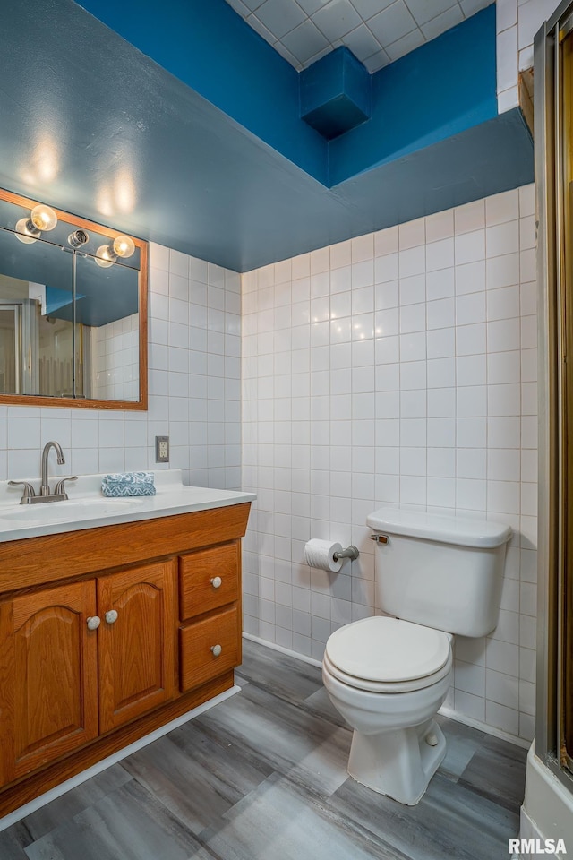 1817 W 3rd St, Milan, IL 61264 - bathroom with tile walls, vanity, and wood finished floors
