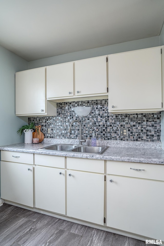 1817 W 3rd St, Milan, IL 61264 - kitchen featuring light countertops, white cabinetry, backsplash, and light wood finished floors