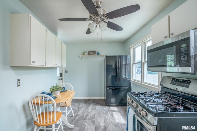 1817 W 3rd St, Milan, IL 61264 - kitchen featuring appliances with stainless steel finishes, ceiling fan, and white cabinets
