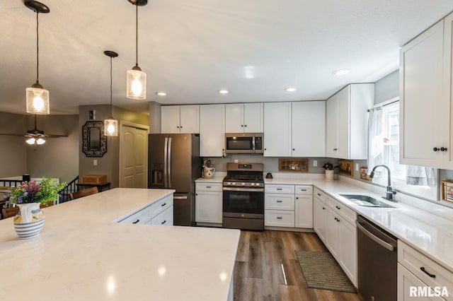 15611 Willow Ct, Sterling, IL 61081 - kitchen with appliances with stainless steel finishes, dark wood-style flooring, white cabinets, decorative light fixtures, and recessed lighting