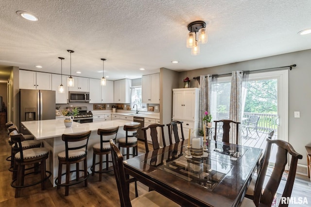 15611 Willow Ct, Sterling, IL 61081 - dining room with dark wood finished floors, a textured ceiling, and recessed lighting