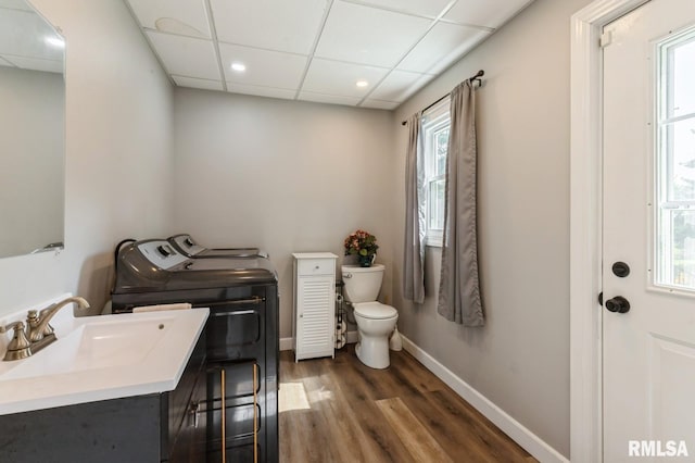 15611 Willow Ct, Sterling, IL 61081 - bathroom featuring washing machine and dryer, wood finished floors, a paneled ceiling, recessed lighting, and healthy amount of natural light