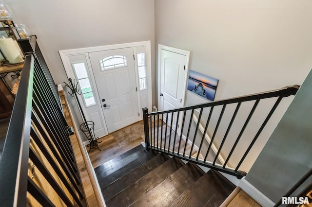 15611 Willow Ct, Sterling, IL 61081 - entryway featuring dark wood-type flooring, a towering ceiling, and stairs