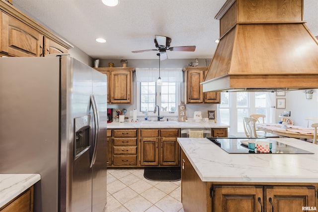 10224 Illinois Steel Rd, Johnston City, IL 62951 - kitchen with stainless steel fridge, custom exhaust hood, ceiling fan, black electric stovetop, and brown cabinetry