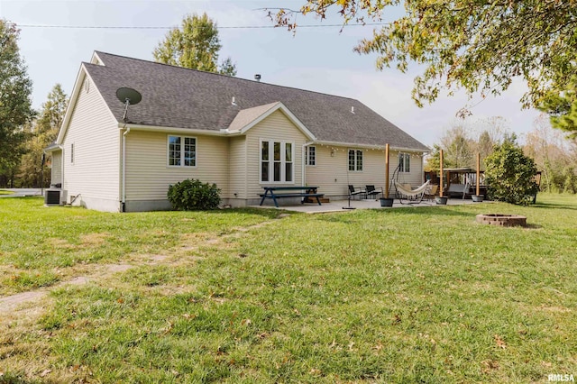 10224 Illinois Steel Rd, Johnston City, IL 62951 - back of property featuring a fire pit, a patio, a yard, and a shingled roof