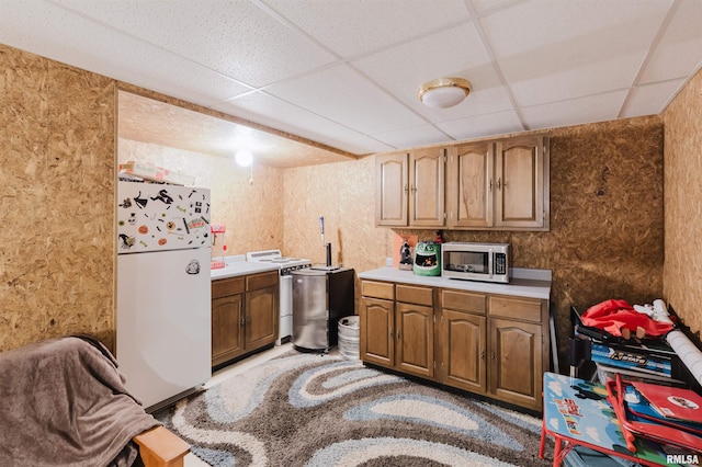 10224 Illinois Steel Rd, Johnston City, IL 62951 - kitchen featuring freestanding refrigerator, stainless steel microwave, a paneled ceiling, light countertops, and stove