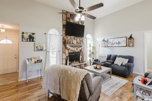 10224 Illinois Steel Rd, Johnston City, IL 62951 - living area featuring high vaulted ceiling, ceiling fan, healthy amount of natural light, and light wood-style floors