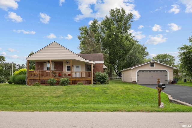 5003 48th St, Moline, IL 61265 - view of front of property featuring a porch, a front lawn, a garage, brick siding, and an outbuilding