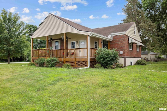 5003 48th St, Moline, IL 61265 - view of front of home with a front yard, brick siding, covered porch, and roof with shingles