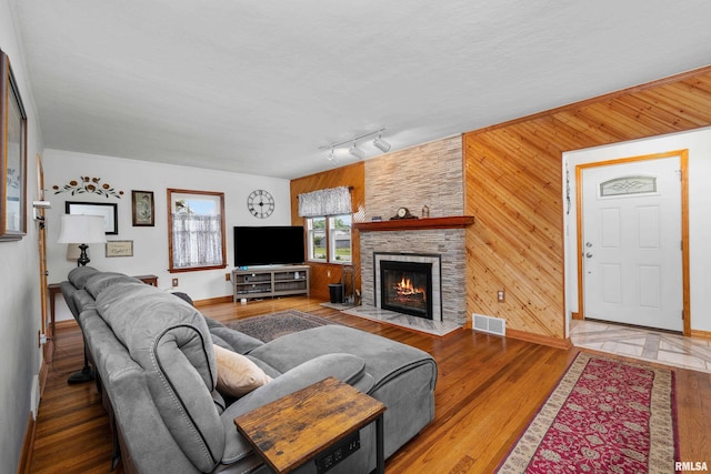 5003 48th St, Moline, IL 61265 - living area with wood finished floors, a fireplace, wooden walls, and track lighting