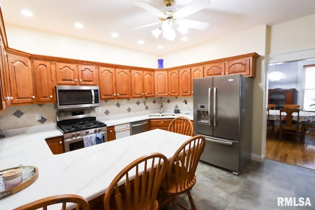2024 Lind St, Quincy, IL 62301 - kitchen with appliances with stainless steel finishes, light countertops, decorative backsplash, ceiling fan, and recessed lighting