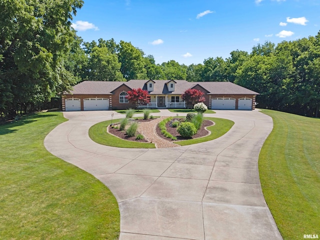 627 10th Ave, Silvis, IL 61282 - view of front facade featuring curved driveway, a garage, and a front yard