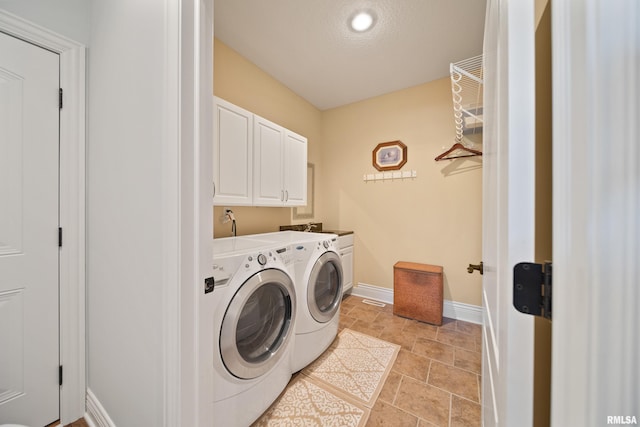 627 10th Ave, Silvis, IL 61282 - washroom featuring cabinet space, washer and dryer, and light stone finish flooring
