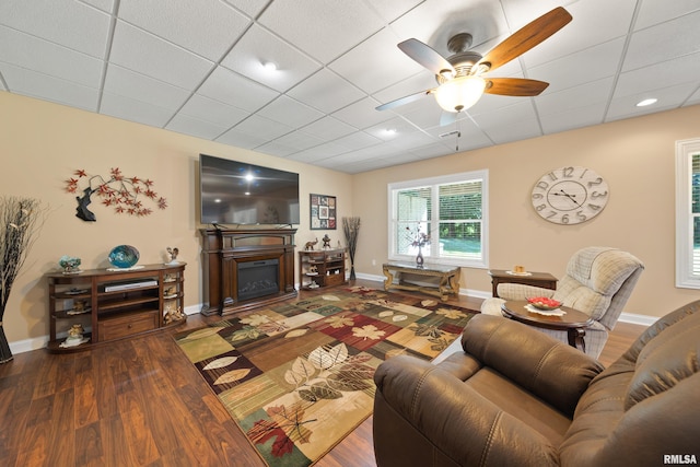 627 10th Ave, Silvis, IL 61282 - living room featuring ceiling fan, wood finished floors, a drop ceiling, and a fireplace