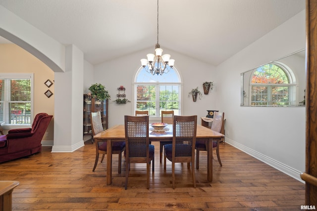 627 10th Ave, Silvis, IL 61282 - dining area featuring a chandelier, plenty of natural light, hardwood / wood-style flooring, and vaulted ceiling