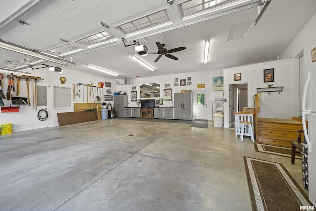 627 10th Ave, Silvis, IL 61282 - garage featuring a garage door opener, ceiling fan, and electric panel