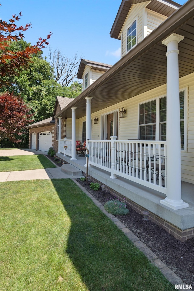 627 10th Ave, Silvis, IL 61282 - view of side of property featuring covered porch, a lawn, concrete driveway, and an attached garage