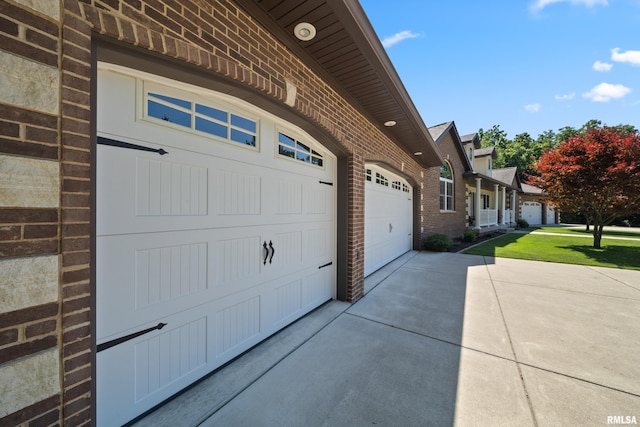 627 10th Ave, Silvis, IL 61282 - view of side of property featuring brick siding, driveway, a garage, and a yard