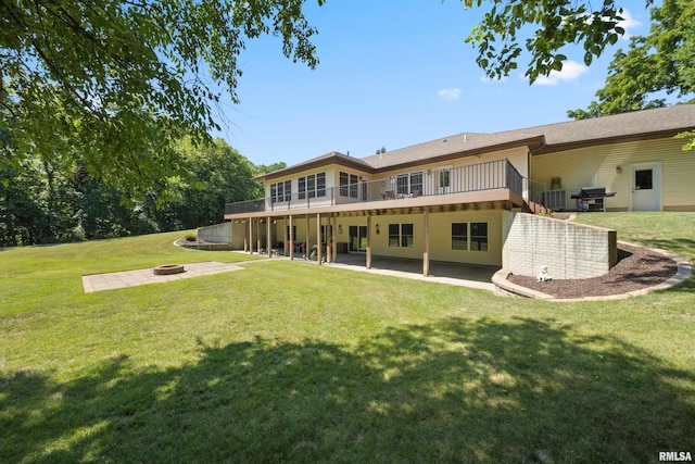 627 10th Ave, Silvis, IL 61282 - rear view of property featuring a fire pit, a patio, and a lawn