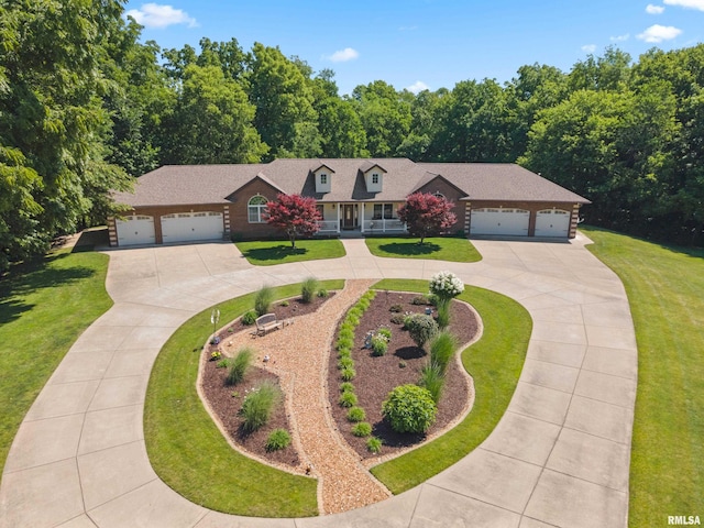 627 10th Ave, Silvis, IL 61282 - view of front of property featuring curved driveway, an attached garage, and a front yard