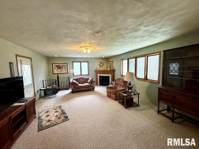1626 210th St, Reynolds, IL 61279 - living area featuring light colored carpet, a textured ceiling, and a fireplace