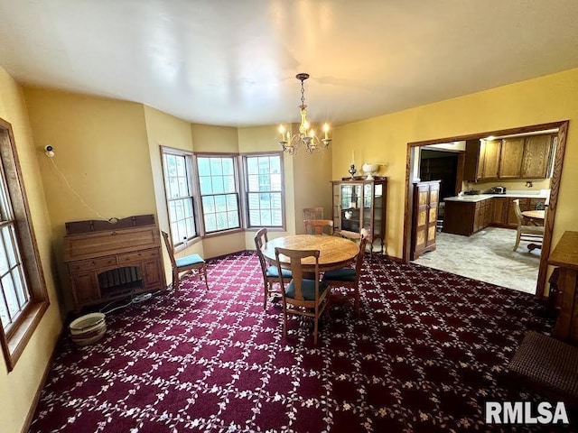 1626 210th St, Reynolds, IL 61279 - dining area featuring a chandelier and light colored carpet