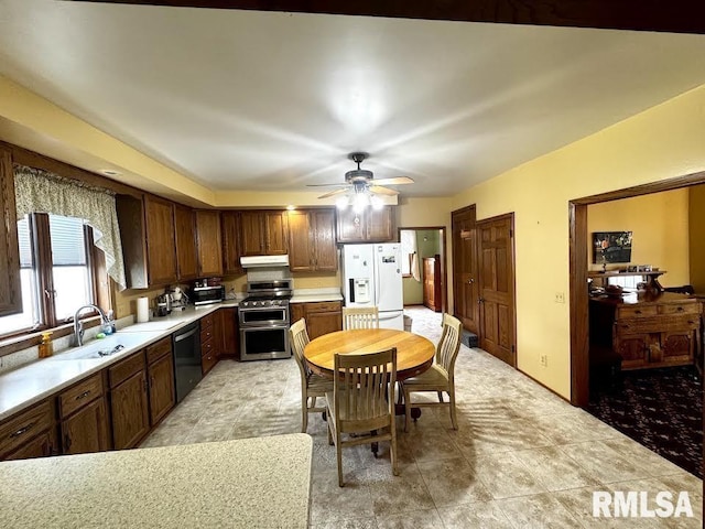 1626 210th St, Reynolds, IL 61279 - kitchen featuring range with two ovens, white refrigerator with ice dispenser, under cabinet range hood, light countertops, and dishwashing machine