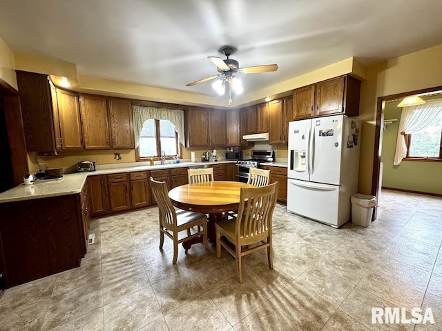 1626 210th St, Reynolds, IL 61279 - kitchen with white fridge with ice dispenser, range with two ovens, light countertops, and healthy amount of natural light