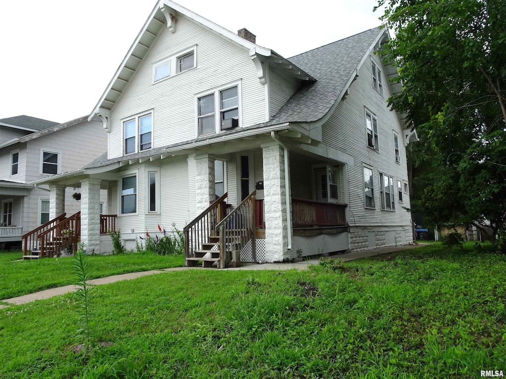 2529-2531 7th Ave, Rock Island, IL 61201 - victorian house with a chimney, a front yard, a shingled roof, and covered porch