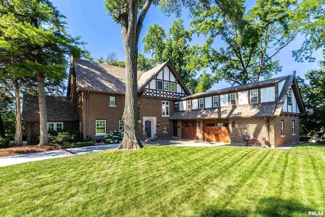 118 Ridgewood Ave, Davenport, IA 52803 - back of house with brick siding, a lawn, and a garage
