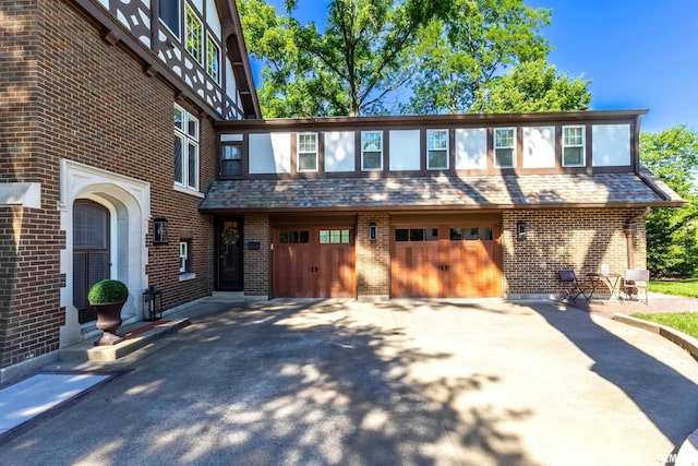 118 Ridgewood Ave, Davenport, IA 52803 - view of property featuring an attached garage, brick siding, and driveway