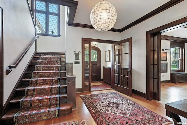 118 Ridgewood Ave, Davenport, IA 52803 - foyer entrance with wood finished floors, stairway, plenty of natural light, and ornamental molding
