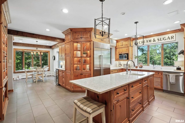 118 Ridgewood Ave, Davenport, IA 52803 - kitchen featuring stainless steel appliances, a chandelier, recessed lighting, light stone counters, and brown cabinetry