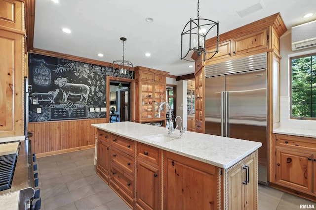 118 Ridgewood Ave, Davenport, IA 52803 - kitchen featuring stainless steel built in refrigerator, hanging light fixtures, wooden walls, a wall mounted air conditioner, and light stone countertops