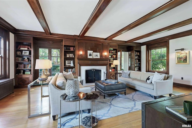 118 Ridgewood Ave, Davenport, IA 52803 - living area with a fireplace, built in shelves, light wood-style floors, beamed ceiling, and wooden walls