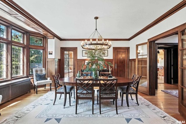 118 Ridgewood Ave, Davenport, IA 52803 - dining room with light wood-style floors, a chandelier, a wainscoted wall, radiator heating unit, and ornamental molding