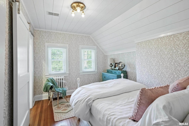 118 Ridgewood Ave, Davenport, IA 52803 - bedroom featuring wallpapered walls, wood finished floors, crown molding, vaulted ceiling, and wooden ceiling