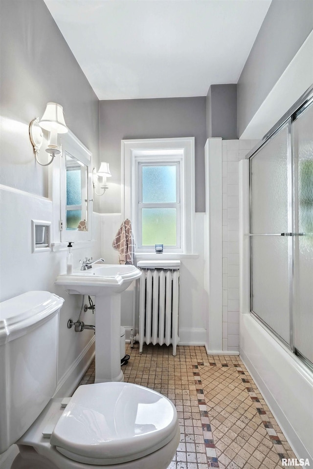 118 Ridgewood Ave, Davenport, IA 52803 - bathroom with radiator heating unit and bath / shower combo with glass door
