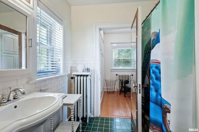 118 Ridgewood Ave, Davenport, IA 52803 - bathroom with radiator, tile patterned flooring, and tile walls