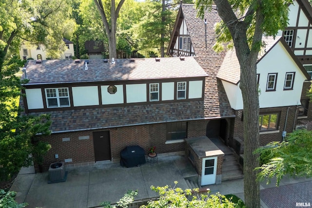 118 Ridgewood Ave, Davenport, IA 52803 - back of property with a patio, brick siding, and a shingled roof