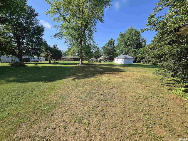 309 E Main St, Clayton, IL 62324 - view of green lawn featuring a detached garage