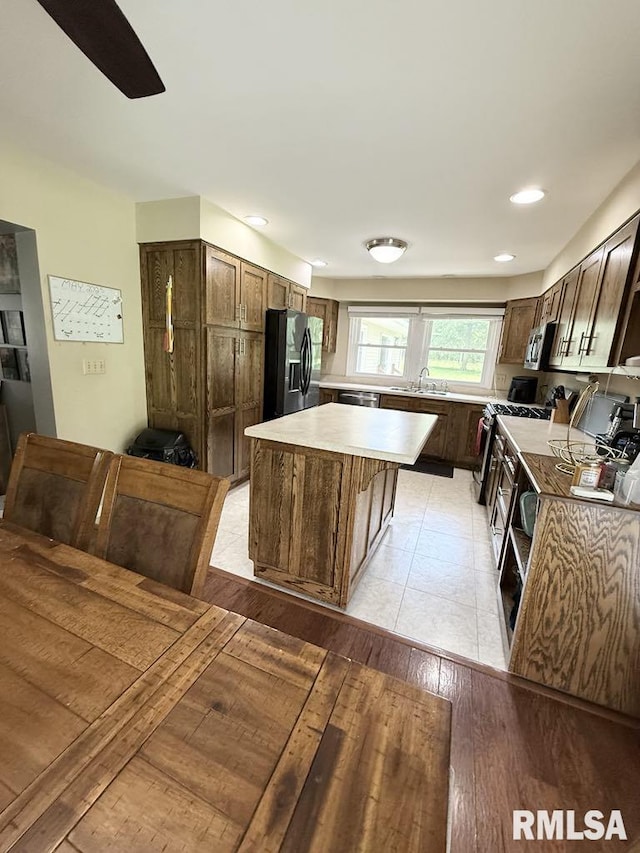 15293 Wall St, Carterville, IL 62918 - kitchen with stainless steel appliances, a center island, light countertops, light wood finished floors, and recessed lighting