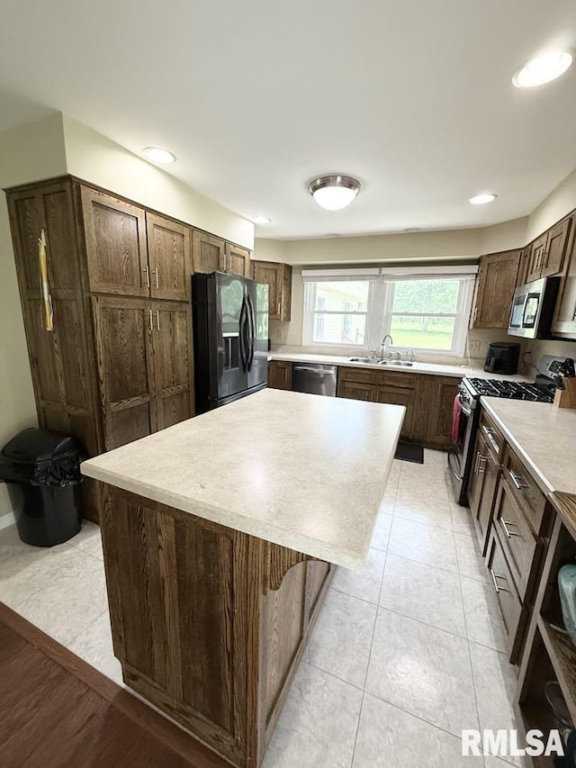 15293 Wall St, Carterville, IL 62918 - kitchen featuring stainless steel appliances, light countertops, a center island, light tile patterned floors, and dark brown cabinets